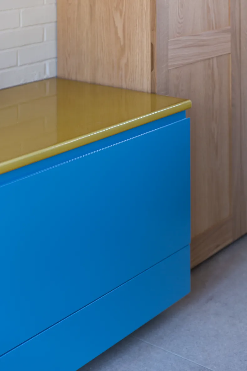 yellow stone counter on blue kitchen cabinet