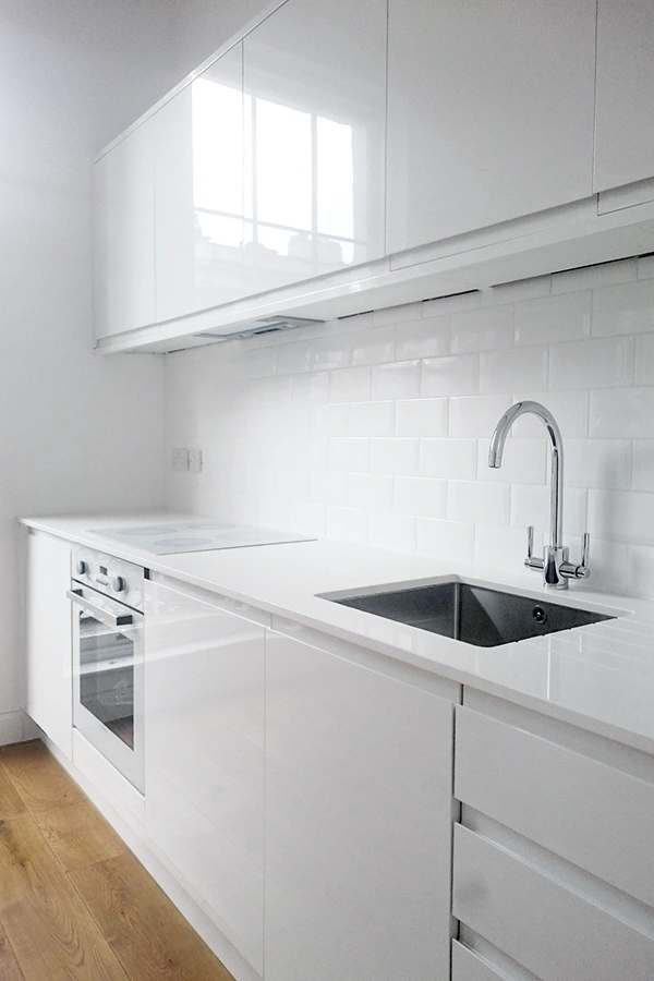 oblique view of white kitchen to apartment
