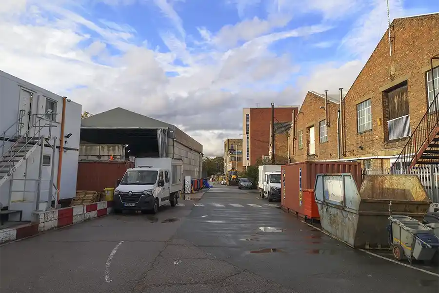 a view behind the warehouses on Lots Road showing the access route which infills over the Kensington Canal