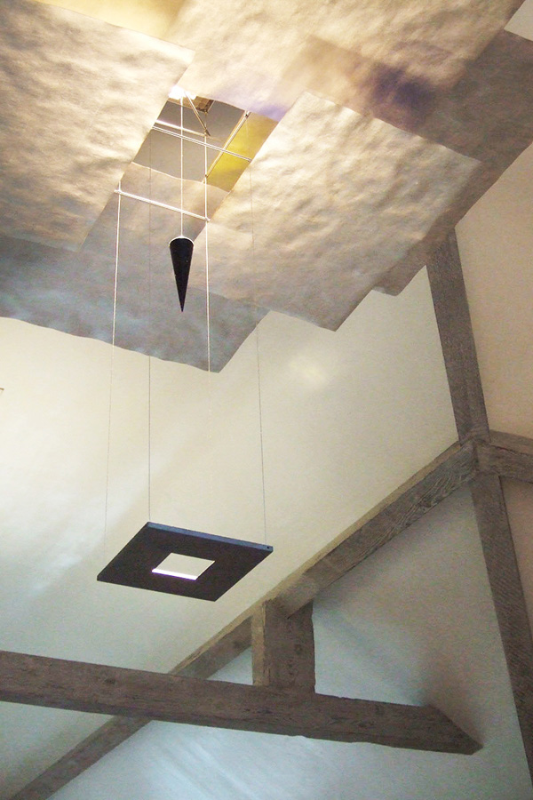 Timber beams paired with a contemporary design light fitting.