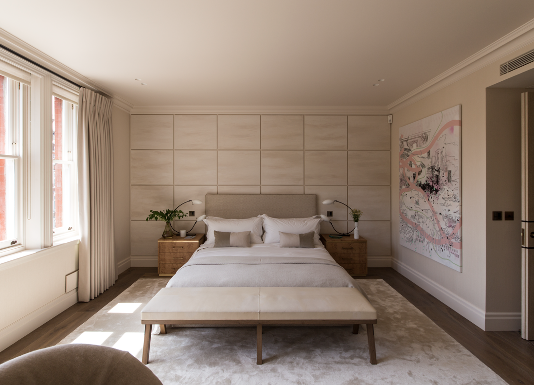 master bedroom with panelled wall