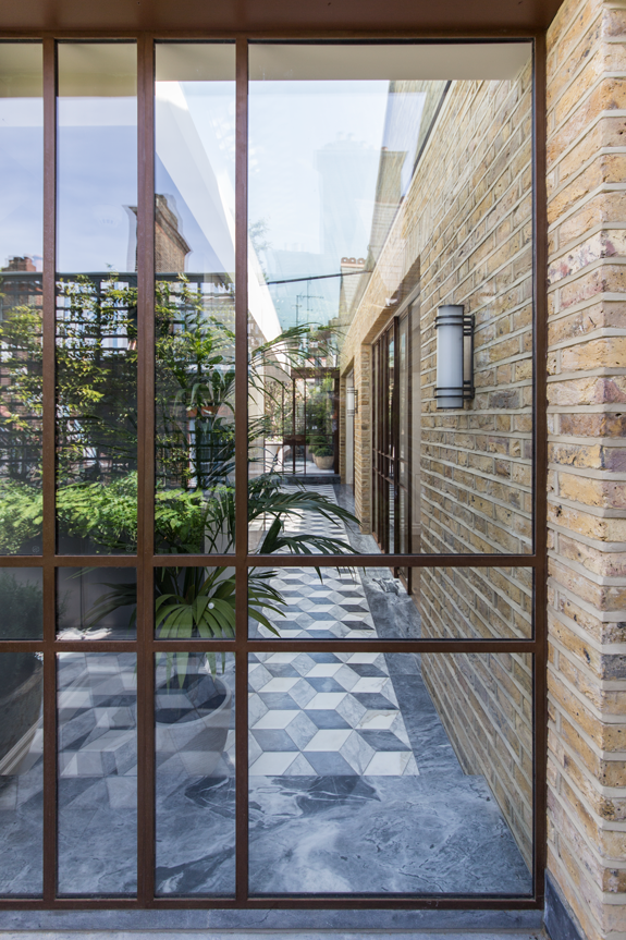 patinated steel frame doors to the roof garden with skylight behind