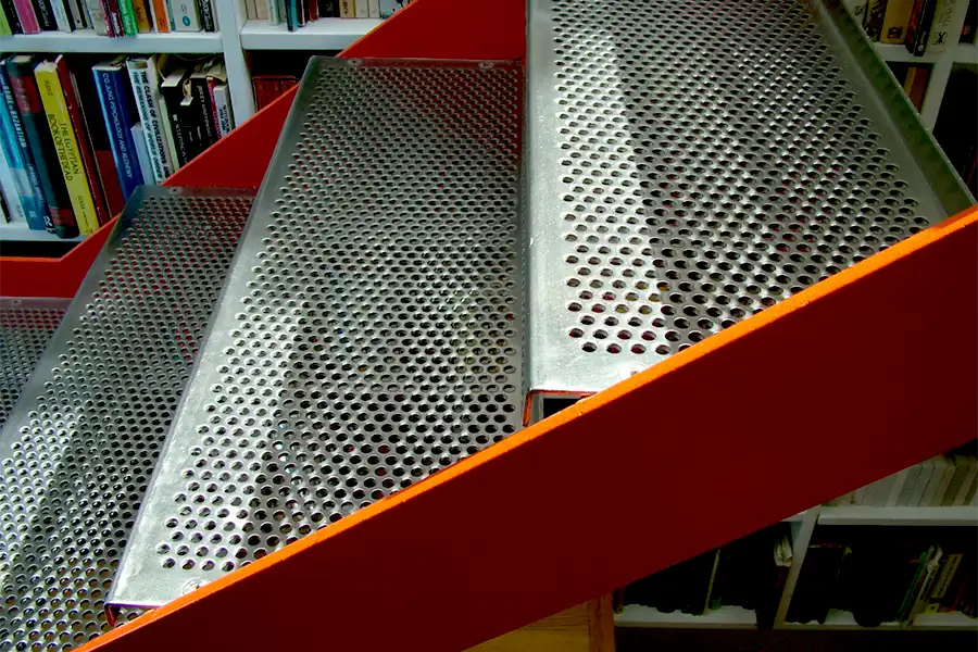 detail of perforated stainless steel treads to upper staircase