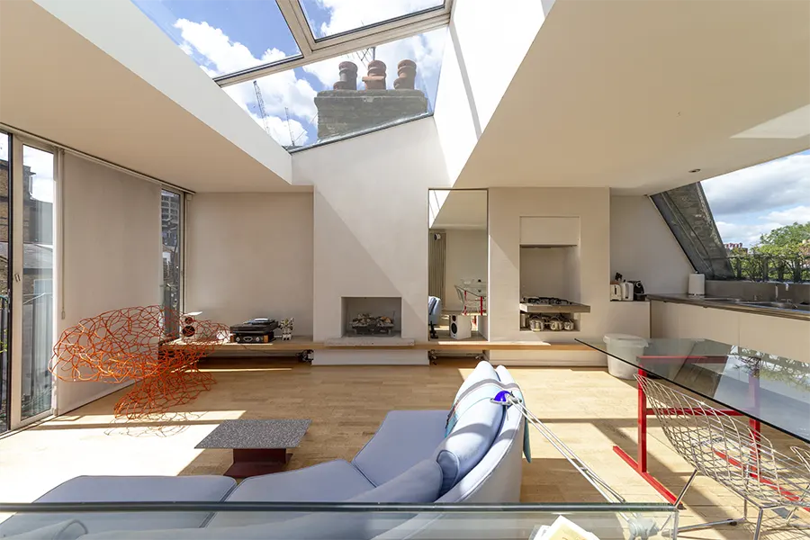 living room with fireplace and skylight