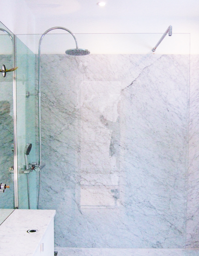 Walk-in shower with glass and marble