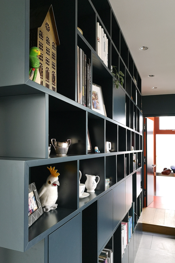 Deep blue custom bookcase on the living room wall