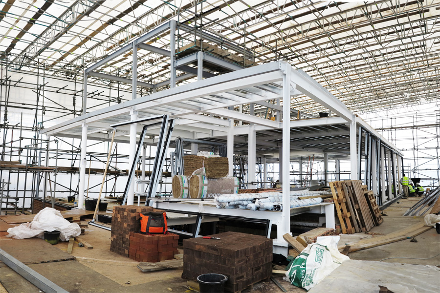 Steel frame under construction, below scaffold