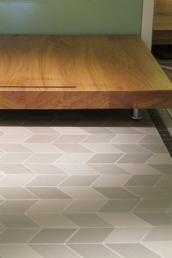Solid oak landing over grey tiled floor