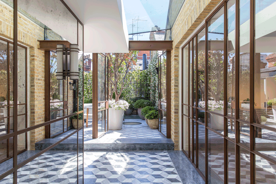 Steel frame glazing with marble floor and planting