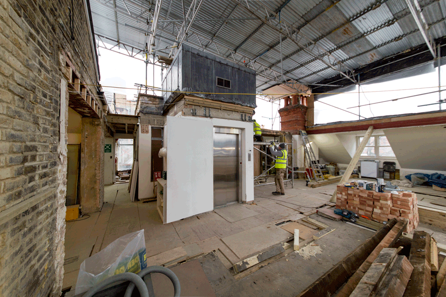 Site demolition in progress around lift