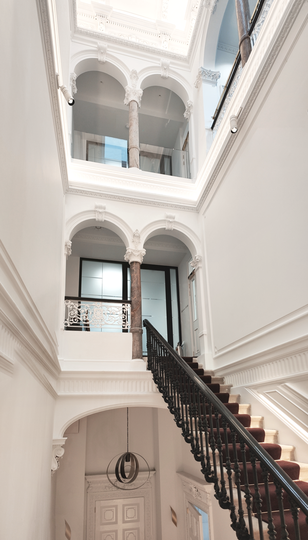 The cantilevered stone staircase within the lightwell