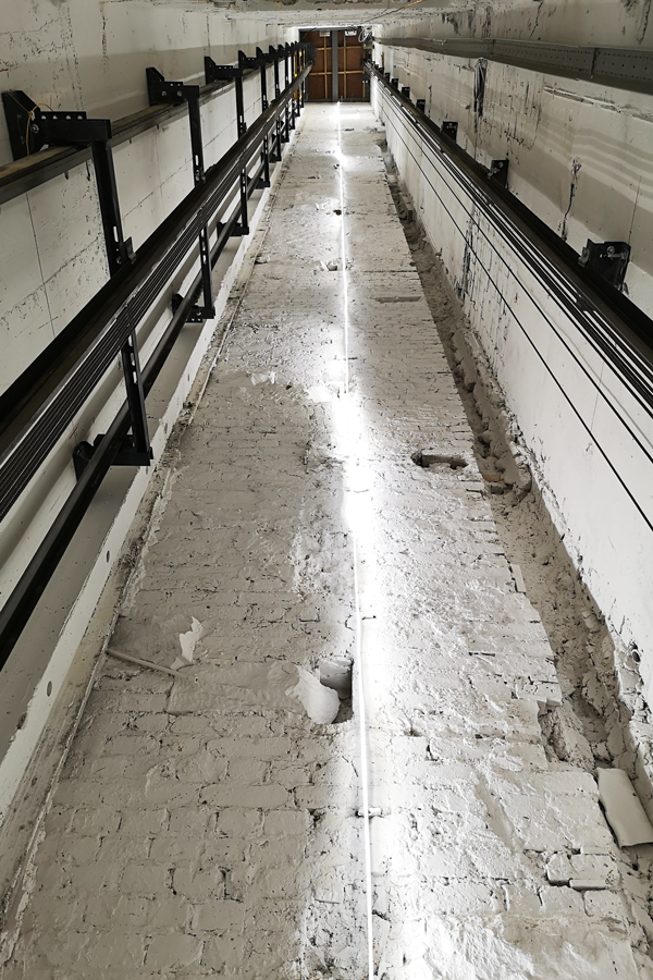 Lift shaft under construction, with traces of the original cantilevered stair