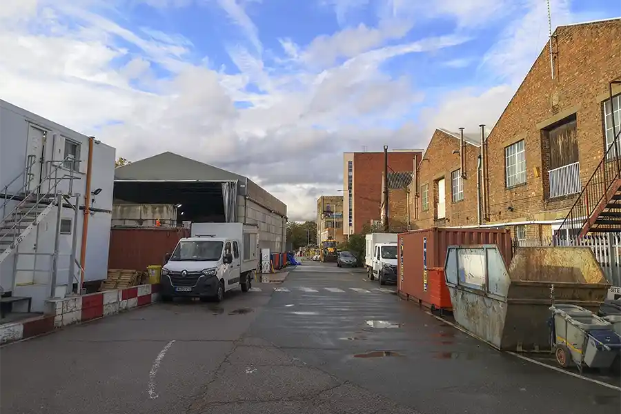 A view behind the warehouses on Lots Road showing the access route which infills over the Kensington Canal