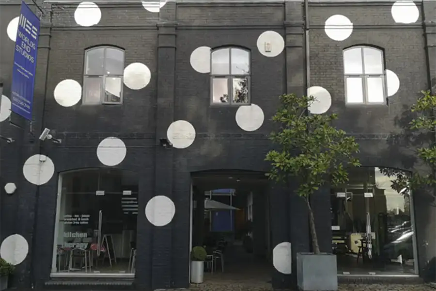 Worlds Ends Studios facade, painted black brick with large white spots