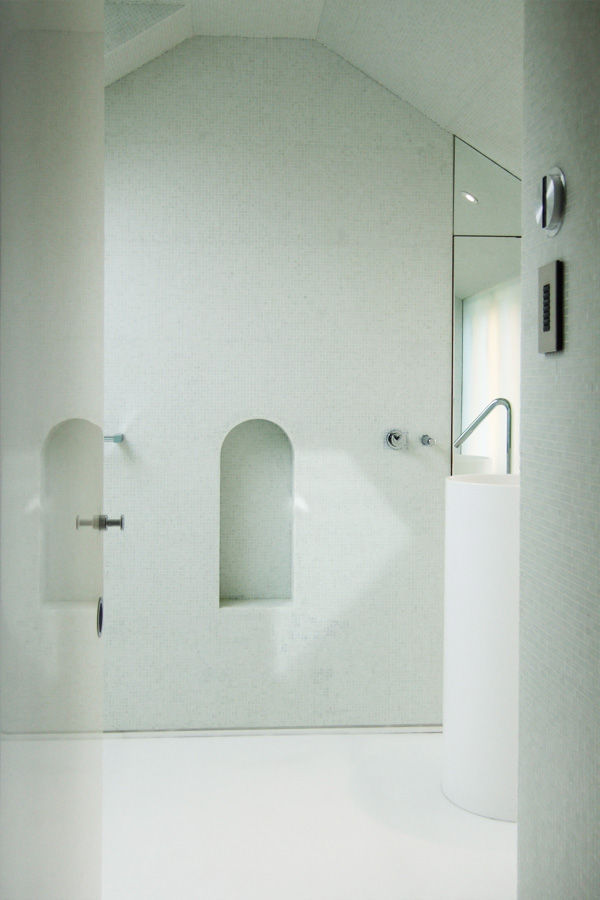 Bathroom sanctuary with mosaic tiles and a ceramic basin