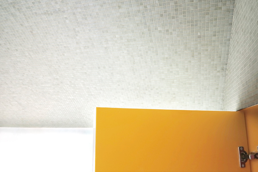 Secret bathroom cabinet with a warm yellow interior