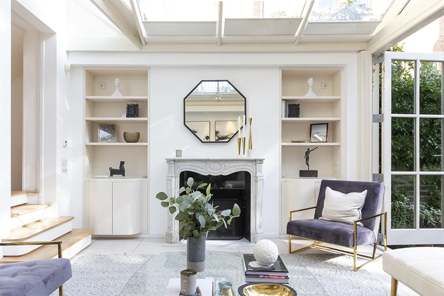 Living room fireplace and shelving, under conservatory roof