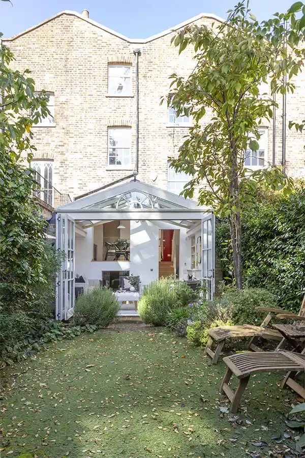 Across the garden to the rear facade and conservatory