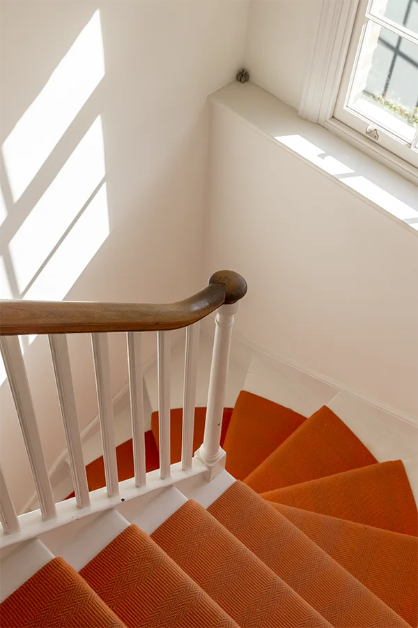 Orange runner on original stair winder and sash window