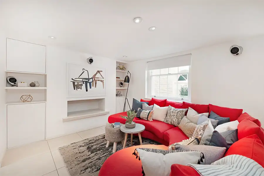 The media room in the basement with custom-designed sofa