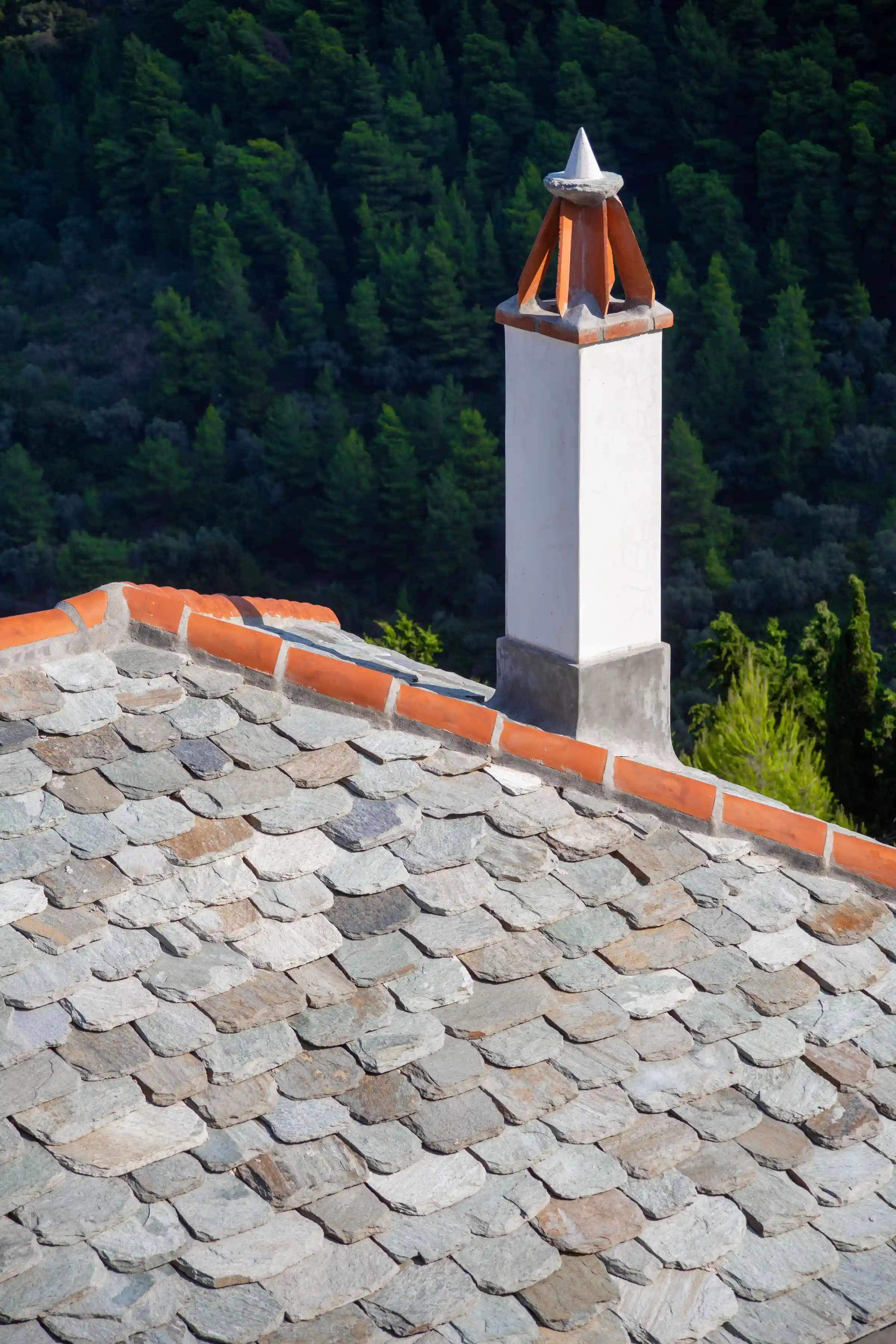 Handworked slate tiles to roof with traditional carrot chimney detail