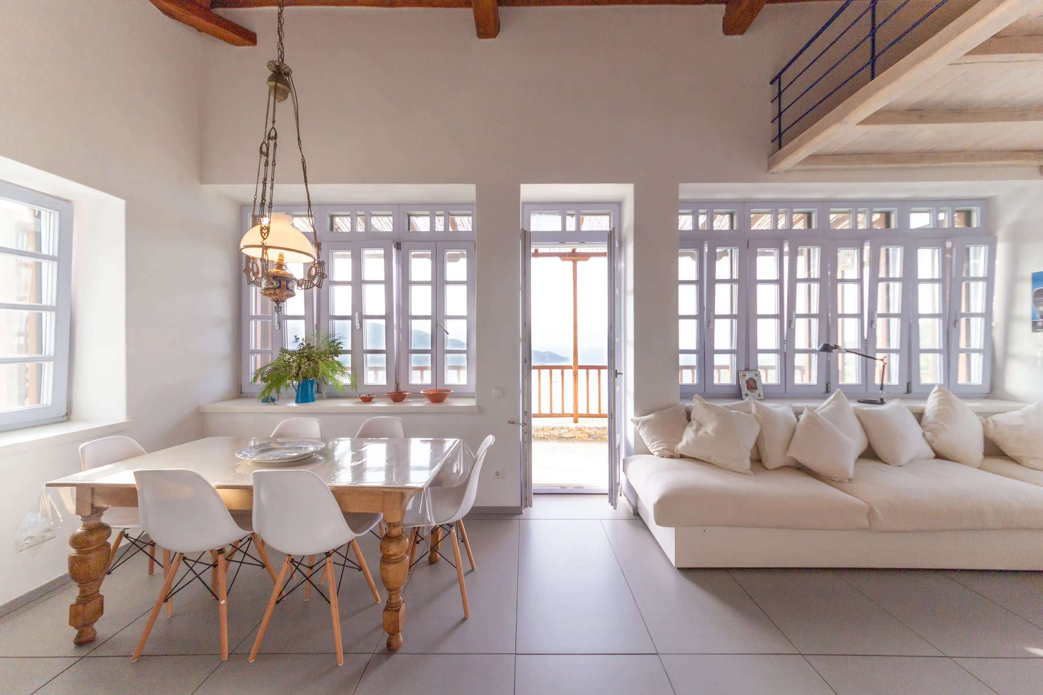 Living and dining area with balcony and sea beyond