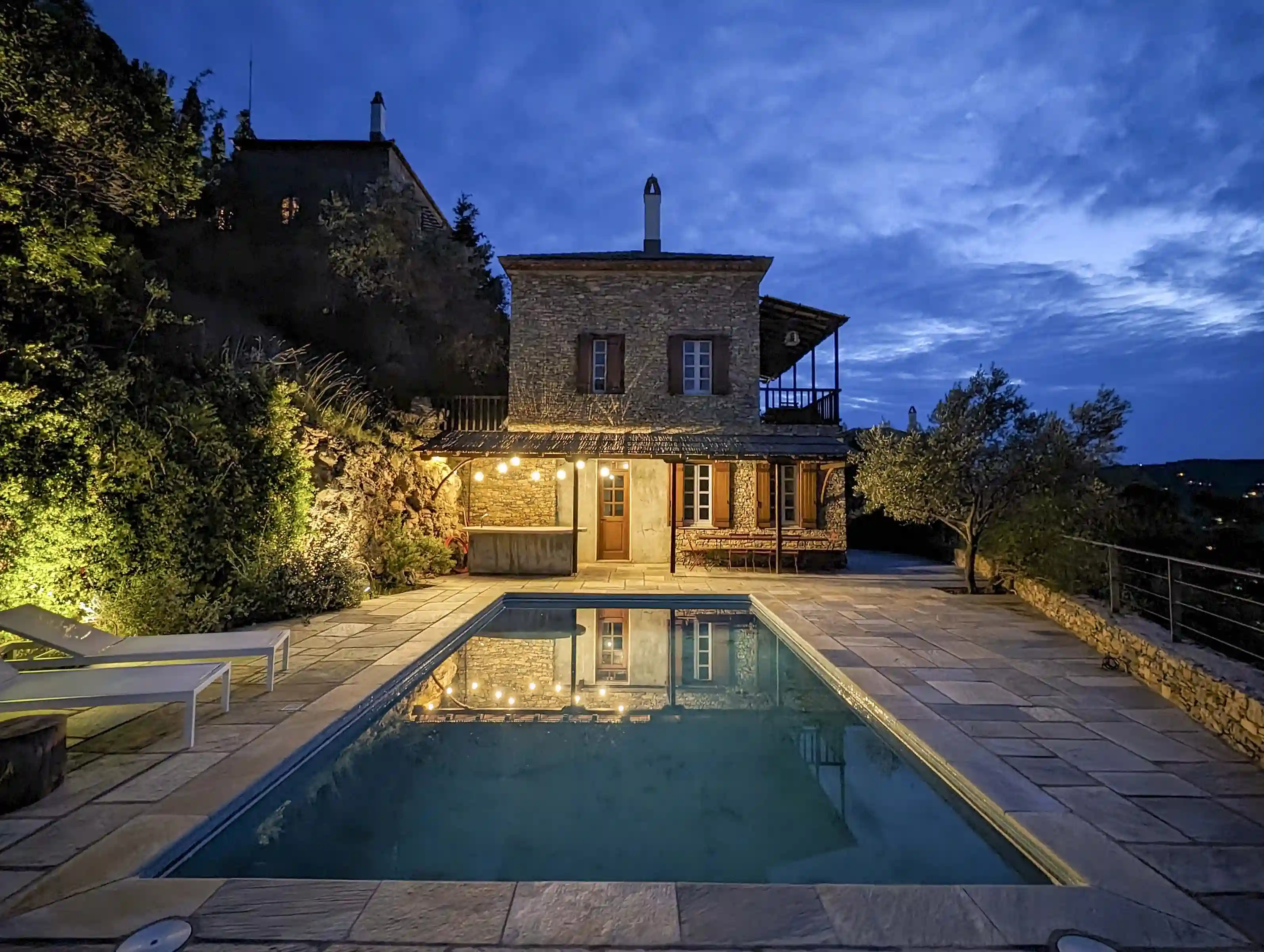 The swimming pool with house 2 in the background