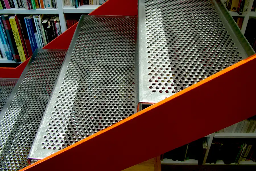 Detail of perforated stainless steel treads to upper staircase