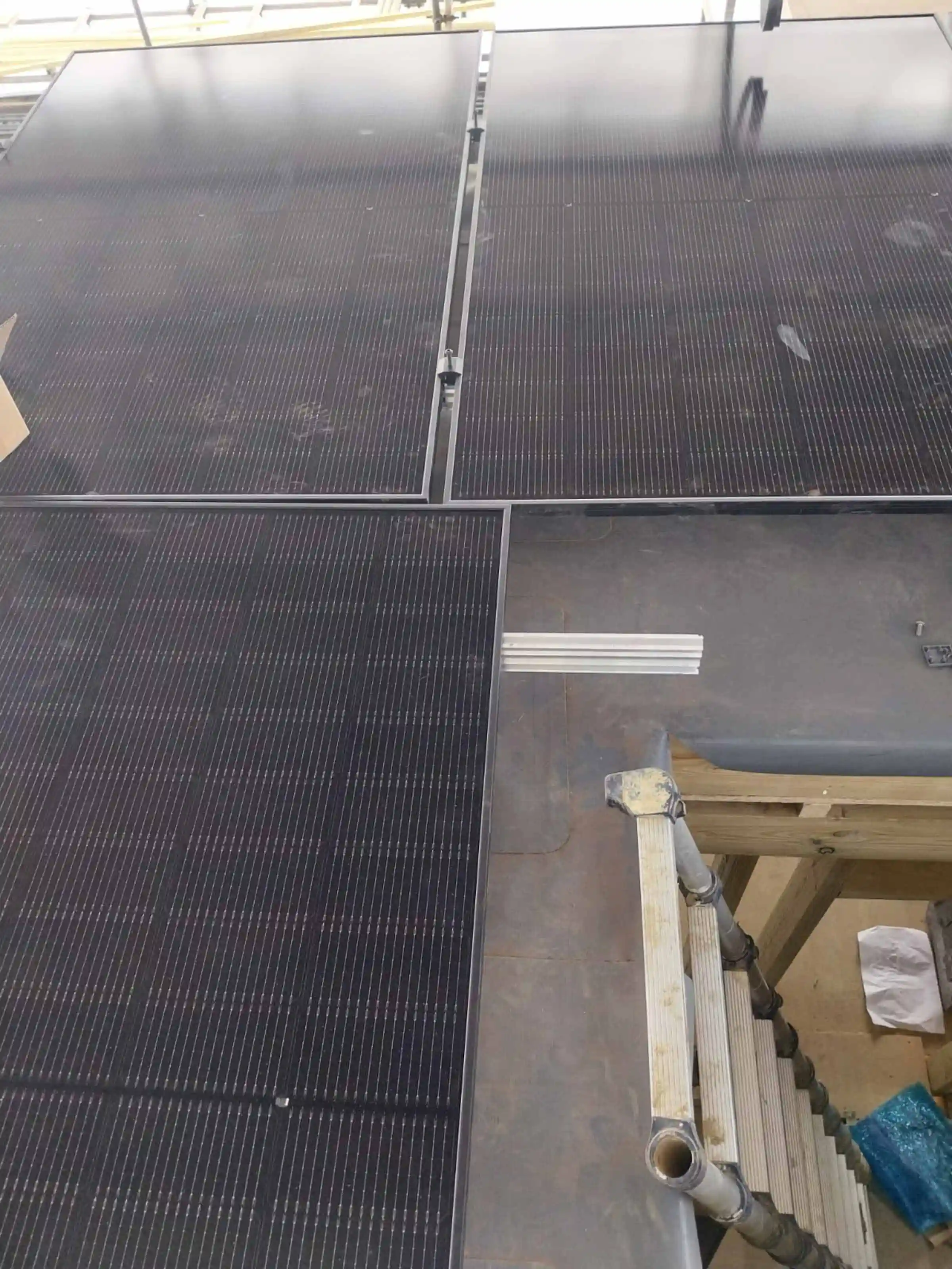 Solar photovoltaic panels being installed to the new extension flat roof