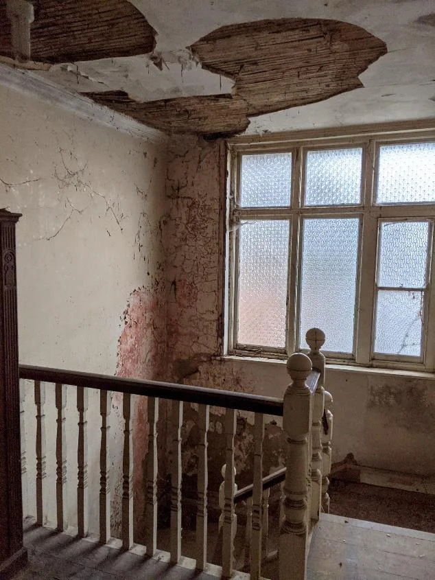 Staverton Road Oxford — before the works, in the entrance hall water had leaked through the roof above, leading to damp walls, collapsing the ceilings and stair landing