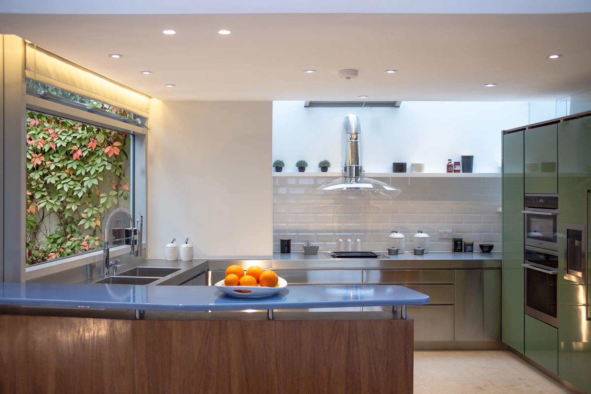 The kitchen with rooflight and lightwell to the left, against the retaining wall