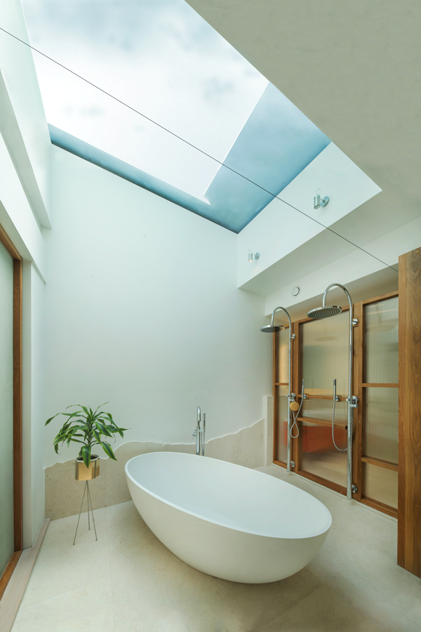 Freestanding bath with skylight over in master ensuite bathroom